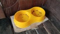 The yellow cat food container in the corner of the front porch of the house Royalty Free Stock Photo