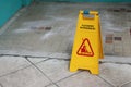 Yellow caution cleaning progress sign on the floor outdoors