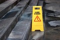 Yellow caution cleaning progress sign on the floor outdoors