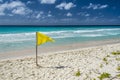 Yellow caution flag on a Barbados beach. Royalty Free Stock Photo