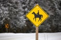 Yellow Caution Horse Riding Sign in a Rural Setting in Winter Royalty Free Stock Photo