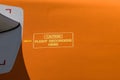 Yellow caution sign on airplane fuselage `caution flight recorders here` Royalty Free Stock Photo