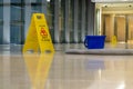 Yellow caution sign showing warning of slippery wet floor Royalty Free Stock Photo