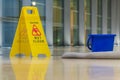 The yellow caution sign showing warning of slippery wet floor Royalty Free Stock Photo