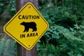 A yellow caution sign with the silhouette of a bear, warning visitors of bear activity Royalty Free Stock Photo