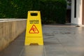 Yellow Caution Slippery Wet Floor Sign Showing and Warning of Caution Wet Floor on the Walk Way Royalty Free Stock Photo
