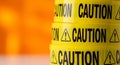 Yellow caution tape rolls stacked vertically. Each roll bears Royalty Free Stock Photo