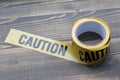 Yellow caution tape on a wooden background. Safety Barrier For Police Barricade, For Contractors