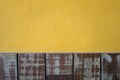 Yellow cement walls and pastel wood planks texture background Royalty Free Stock Photo