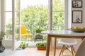 Yellow chair on the balcony of elegant kitchen interior, real photo