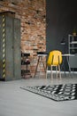 Yellow chair at desk in industrial workspace interior with cabin