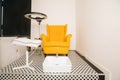 Yellow chair in pedicure salon. organization of work place for the master of foot and nail care