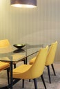 Yellow chairs with glass table in dinning room Royalty Free Stock Photo