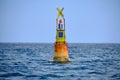 Yellow channel marker buoy floating in the sea - lighthouse nautical Royalty Free Stock Photo