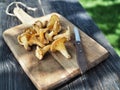 Yellow chanterelle mushrooms with knife on rustic wooden table Royalty Free Stock Photo