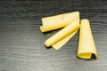Yellow cheese rolled into rolls. Royalty Free Stock Photo