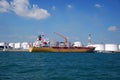 Yellow Chemical tanker in Singapore anchorage.