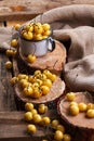 Yellow cherry in a rustic style on a wooden background. Berries of ripe fresh cherries in a cup. Royalty Free Stock Photo