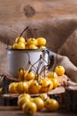 Yellow cherry in a rustic style on a wooden background. Berries of ripe fresh cherries in a cup. Royalty Free Stock Photo