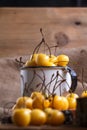 Yellow cherry in a rustic style on a wooden background. Berries of ripe fresh cherries in a cup. Royalty Free Stock Photo