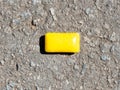 Yellow chewing gum lies on the pavement