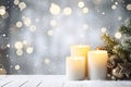 Yellow Christmas burning candles and green spruce branches still life. Royalty Free Stock Photo