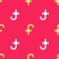 Yellow Christmas candy cane with stripes icon isolated seamless pattern on red background. Merry Christmas and Happy New Royalty Free Stock Photo