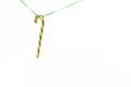 Yellow Christmas pendant decorative lollipop with green rope isolated on white background