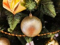 Yellow christmas toys on the tree. Golden christmas background of defocused lights with decorated tree Royalty Free Stock Photo