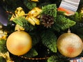 Yellow christmas toys on the tree. Golden christmas background of defocused lights with decorated tree Royalty Free Stock Photo