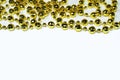 Yellow Christmas tree beads on the top edge on a white background with a copy space Royalty Free Stock Photo