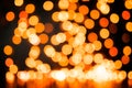 Yellow Christmas Tree Bokeh on black background of defocused glittering lights, Christmas background pattern concept Royalty Free Stock Photo