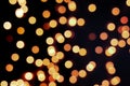 Yellow Christmas Tree Bokeh on black background of defocused glittering lights, Christmas background pattern concept Royalty Free Stock Photo