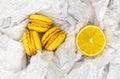 Yellow citrus macaroons and a slice of a fresh cut lemon Royalty Free Stock Photo