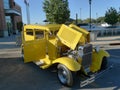 Yellow classic automobile with chrome at car show