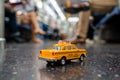 A yellow classic taxi model in New York city subway