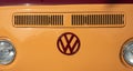 Yellow classic Volkswagen, camper van vehicle front view headlights and logo