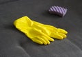 Yellow cleaning gloves and a sponge on the couch, close-up Royalty Free Stock Photo