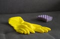 Yellow cleaning gloves and a sponge on the couch, close-up screen Royalty Free Stock Photo