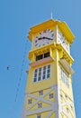 Yellow clock tower with blue sky Royalty Free Stock Photo