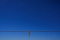 Clothes peg and blue sky background. Royalty Free Stock Photo