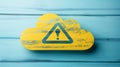 Yellow Cloud Shape with Warning Sign Against a Blue Wooden Background, Data Security Concept Royalty Free Stock Photo