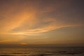 Yellow clouds in the blue purple pink sunset sky against the sea Royalty Free Stock Photo