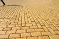 Yellow cobblestone, brick road in Sofia, shadow of pedestrian in the background Royalty Free Stock Photo