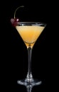 Yellow cocktail decorated with cherry in martini cocktails glass Royalty Free Stock Photo