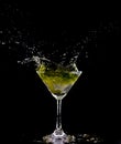 Yellow Cocktail Glass with splashing water alcohol, Crystal Cocktail drink splatter splash in air and bubble from glass. Liquor Royalty Free Stock Photo