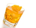 Yellow cocktail tilted with orange slice isolated on white background