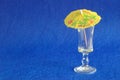 A yellow cocktail umbrella displayed with an empty shooter glass Royalty Free Stock Photo