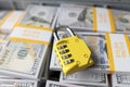 Yellow code lock on top of pile of cash