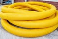 Yellow coil land drainage pipe on the ground, it is used to remove excessive water from fields and gardens